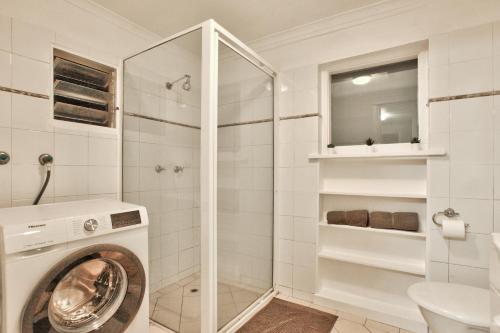 a washing machine in a bathroom with a washer at 3 Bedrooms - Darling Harbour - Glebe St 2 E-Bikes Included in Sydney
