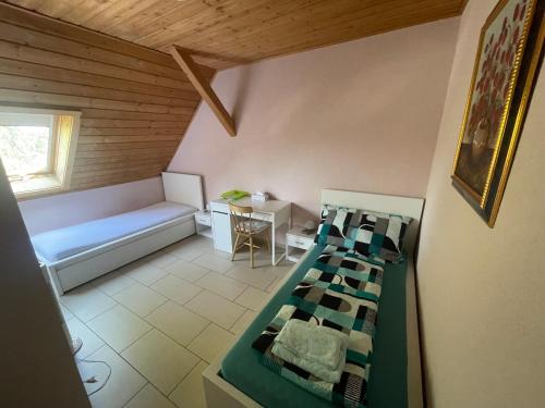 a room with a bed and a table and a couch at Bed-International in Roggwil