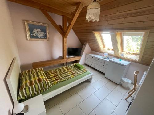 a bedroom with a bed and a desk in a room at Bed-International in Roggwil