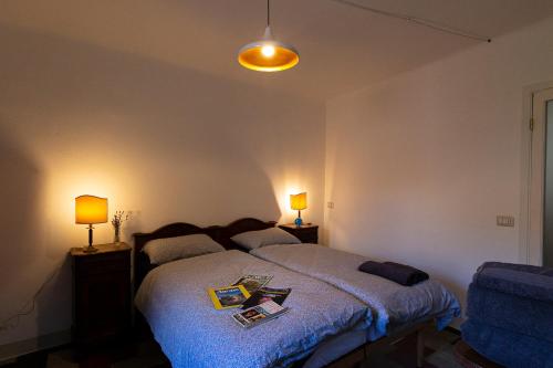 a bedroom with a bed and two lamps on tables at Fiordaliso Apartment in Como