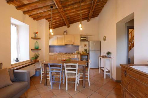 a kitchen and dining room with a table and chairs at Agriturismo Casale le Crete in Acquapendente