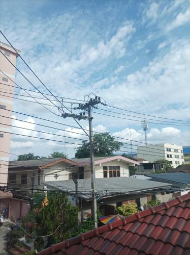 a utility pole with power lines in a city at JATUPORN A3 in Ban Talat Rangsit
