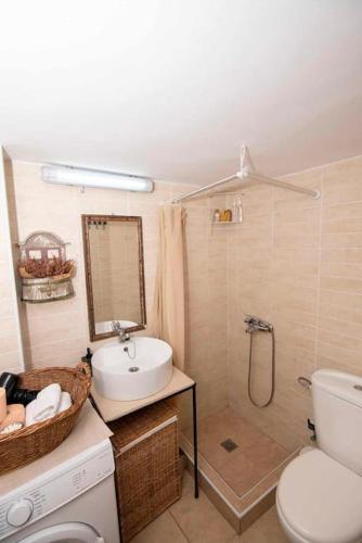 a bathroom with a toilet and a sink and a shower at Ammoudara Apartment's in Kalymnos