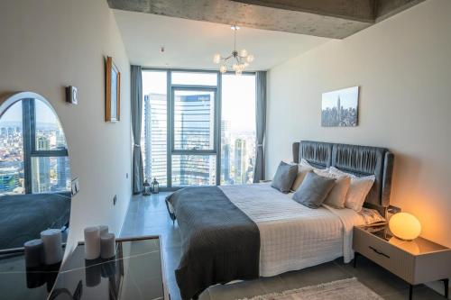 a bedroom with a large bed with a large window at City View Apt - Panoramic Views Of The City in Istanbul