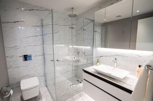 a bathroom with a glass shower and a sink at City View Apt - Panoramic Views Of The City in Istanbul