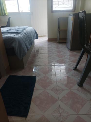 a room with a bed and a tiled floor at JATUPORN A3 in Ban Talat Rangsit