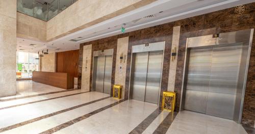 a row of elevator doors in a building at Worth Elite Hotel in Makkah