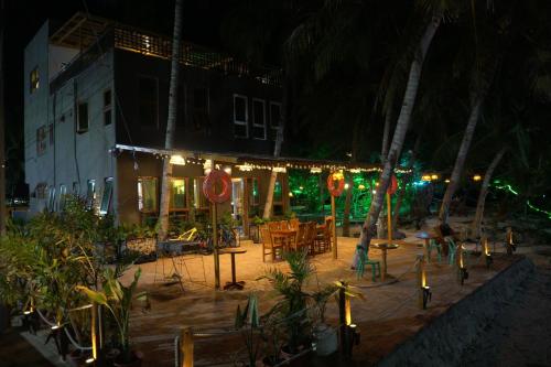 a building with christmas lights on it at night at L Cafe Restobar & Lyn's Guest House in San Juan