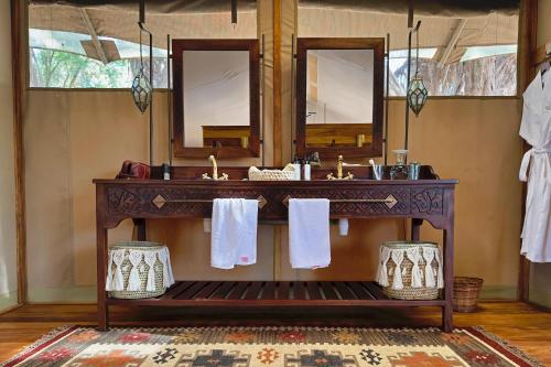 a bathroom with a sink and a mirror at Soroi Larsens Camp in Buffalo Springs  National Reserve