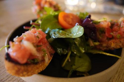 a plate of food with a salad on a table at Hafen 17 Hotel Küche Bar in Kehl am Rhein