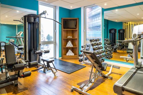 a gym with treadmills and exercise equipment in a building at Novotel Leeds Centre in Leeds