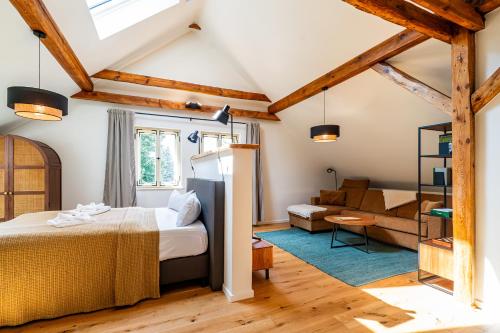 a bedroom with a bed and a living room at Landwarenhaus Gross Beuchow in Groß Beuchow