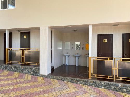 a bathroom with two toilets in a building at Park-hotel Abkhazia in Tsandrypsh