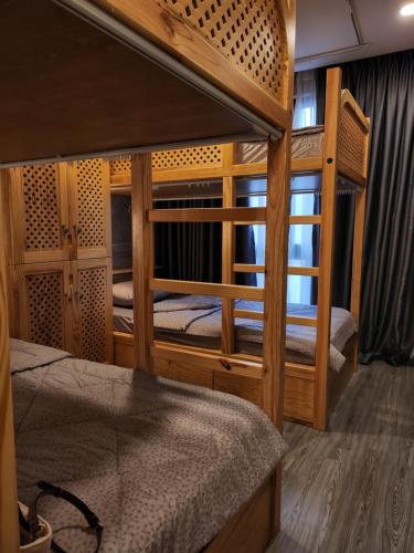 a room with two bunk beds and a window at HALF Coffee N Dorm in Ho Chi Minh City