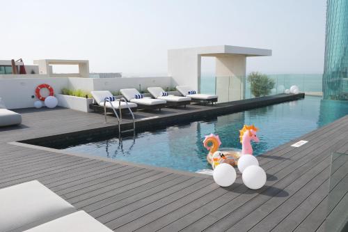 two toy horses sitting on the edge of a swimming pool at Charthouse Bahrain in Manama