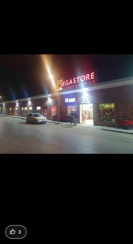 a mexican store with a car parked outside at night at Villa Vishnyovka in Baku
