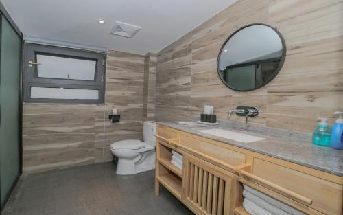 a bathroom with a sink and a mirror at Cozy Boutique Hotel in Zhangjiajie
