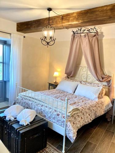 a bedroom with a large bed with a canopy at Piccola dimora accogliente e molto panoramica in Tagliacozzo
