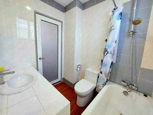 a white bathroom with a toilet and a sink at Good2Stay Apartment 6-8pax l 3R2B l 2 Parking l Coway Water l Unifi I Swimming Pool in Melaka
