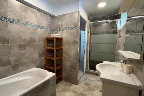 une salle de bain avec une baignoire, un lavabo et une douche dans l'établissement La Savinienne de Cassis- 5mn port plage face mer, à Cassis