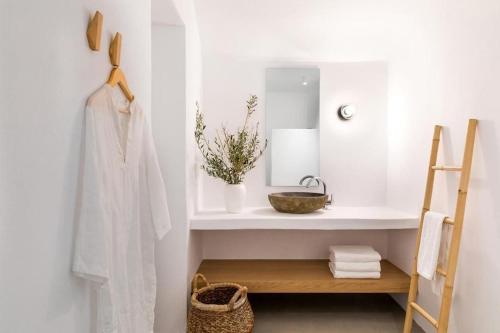 La salle de bains blanche est pourvue d'une étagère et d'un miroir. dans l'établissement Platinum Paros Villa - Villa Azure - 5 Bedrooms - Sea Views & Private Pool - Naoussa, à Kolympithres