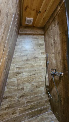 a bathroom with a shower with a wooden wall at Peaks of Prokletije - Outdoor pool in Gusinje