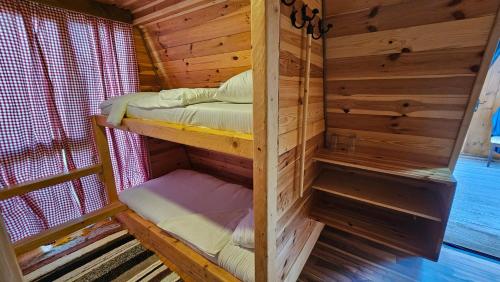 a wooden cabin with two bunk beds in it at Peaks of Prokletije - Outdoor pool in Gusinje