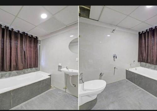 a bathroom with a toilet and a tub and a sink at hotel stay inn in Ahmedabad