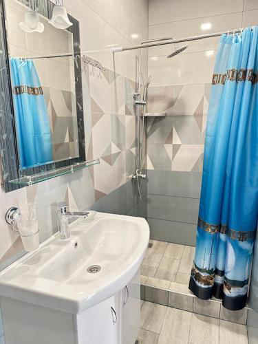 a bathroom with a sink and a shower at Yenokyans' Riverside Hotel in Areni