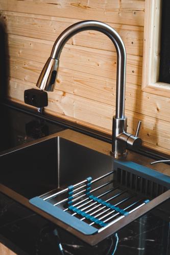 a sink with a faucet in a kitchen at Lonely Mountain in Kazbegi