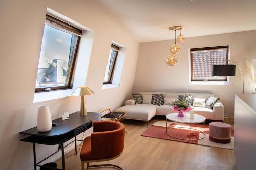 a living room with a couch and a table at Hôtel Restaurant Vaillant proche Europapark Rulantica in Sélestat