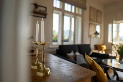 a living room with a table with two candles on it at Vila Heide in Česká Kamenice