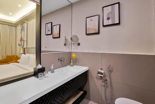 a bathroom with a sink and a mirror at Pramod Lands End Resort, a member of Radisson Individuals in Gopālpur