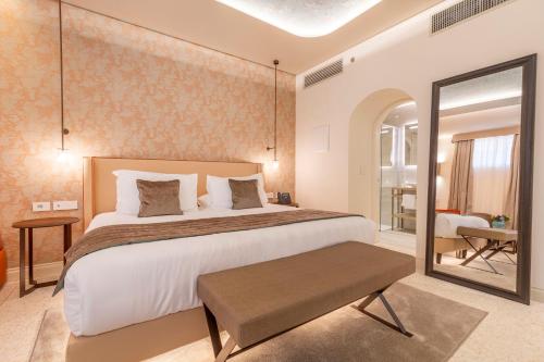 a bedroom with a large bed and a mirror at Palazzo Keller in Venice