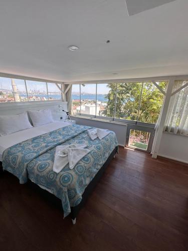 a bedroom with a large bed in a room with windows at Hotel Antique in Istanbul