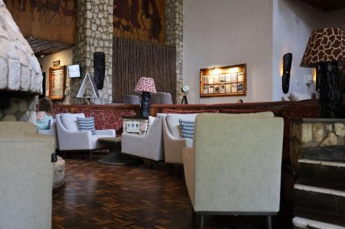 a lobby with couches and chairs in a room at Taita Hills Safari Resort & Spa in Tsavo
