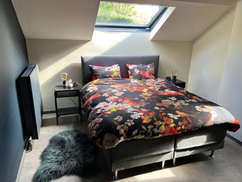 a bedroom with a bed with a floral comforter at Ikigai in Oud-Turnhout