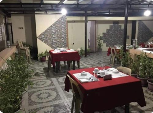 a restaurant with tables with red table cloths on it at Casa Feliciano 