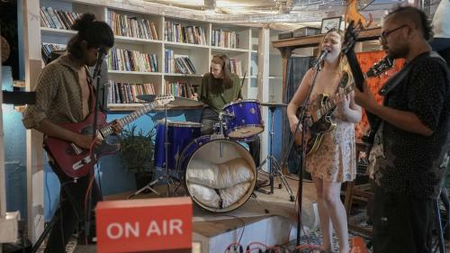 a group of people playing music in a room at Anjoned Hostel & Cafe in Anjuna