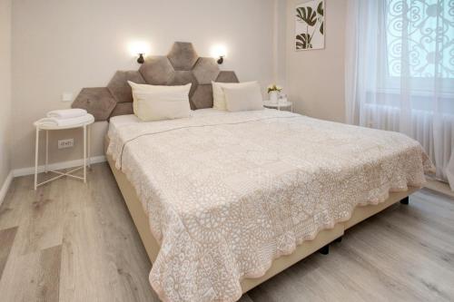 a bedroom with a large bed with a white blanket at Hotel Löhr in Baden-Baden