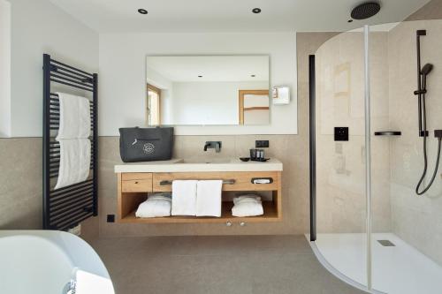 a bathroom with a sink and a shower at Hotel Gletscherblick in Sankt Anton am Arlberg