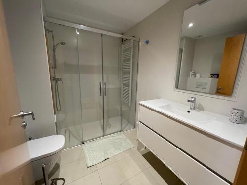 baño blanco con ducha y lavamanos en Apartament vista Viladrau, en Viladrau