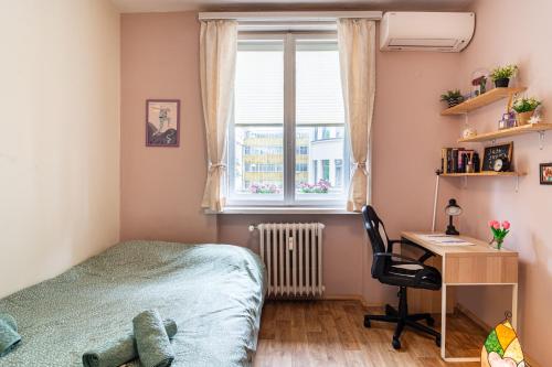 a bedroom with a bed and a desk and a window at The Top Spot - Cute Little Studio in the Center by Flat Mаnager in Sofia