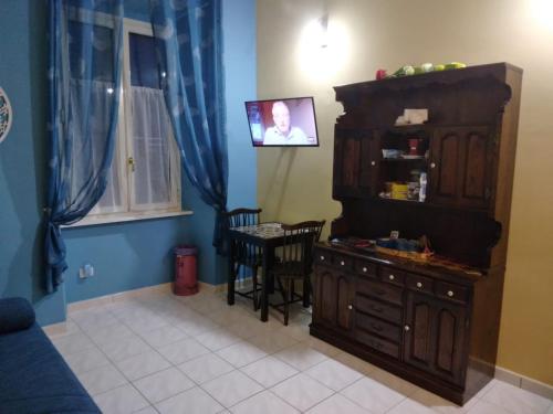 uma sala de estar com um armário e uma mesa com cadeiras em La Casa di Carta FIUGGI em Fiuggi