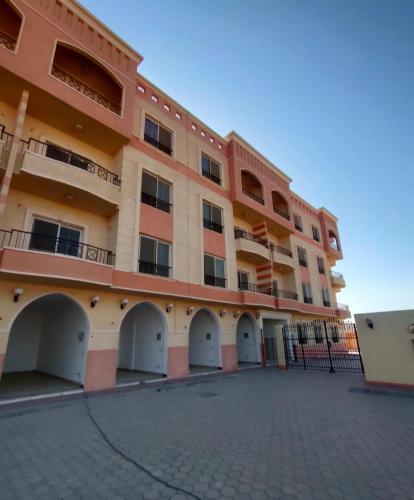 a large building with white doors and a courtyard at منتجع الياقوتة الحمراء in Hurghada