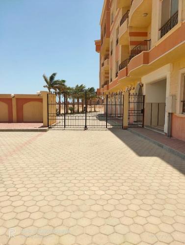 a fence in front of a building with a courtyard at منتجع الياقوتة الحمراء in Hurghada