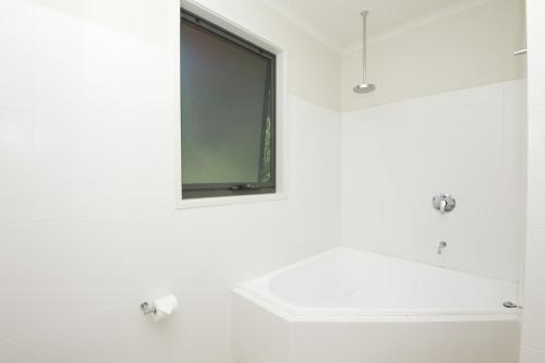 a bathroom with a mirror and a sink at Boom 6 Boomerang Beach in Boomerang Beach