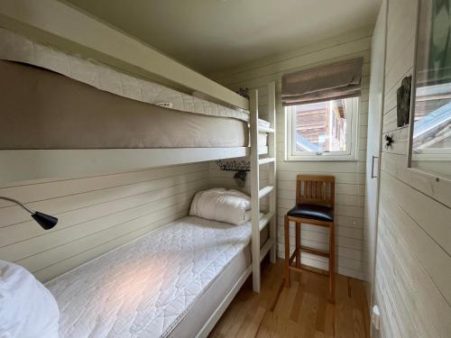 a small room with two bunk beds and a window at Ski Village Funäsdalen in Funäsdalen