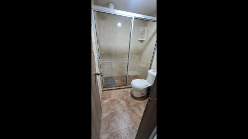 a bathroom with a shower and a toilet at Apartament Riqueza close to El Dorado airport no1 in Bogotá