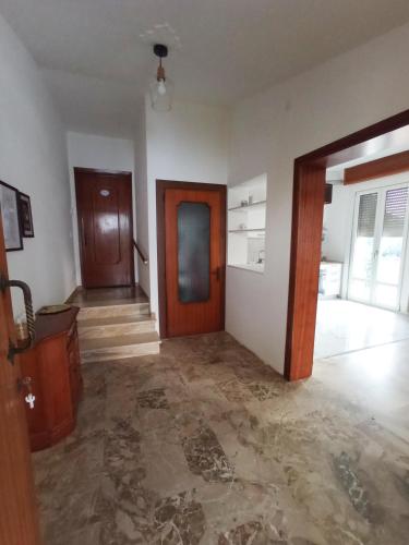 an empty room with a wooden door and a hallway at Lilly's Home in Castelfranco Veneto